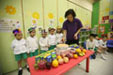 Chrildren are having plain cake and fruit in the birthday party