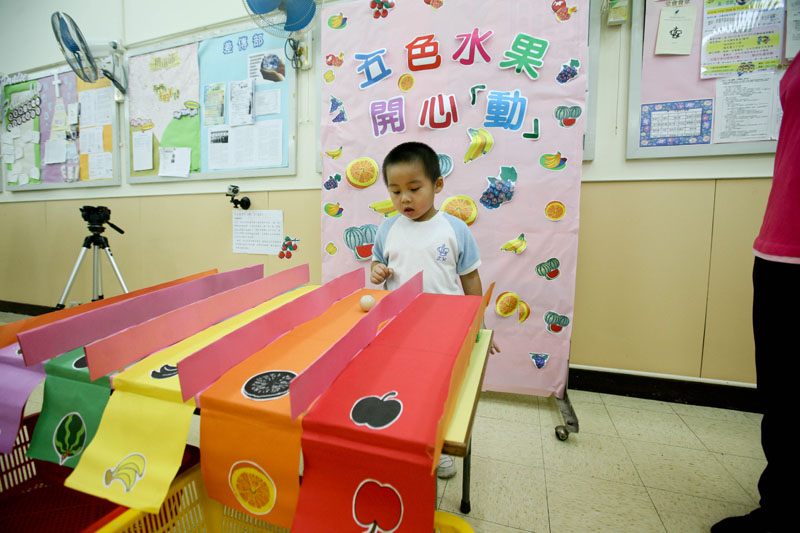 A child is playing a fruit game