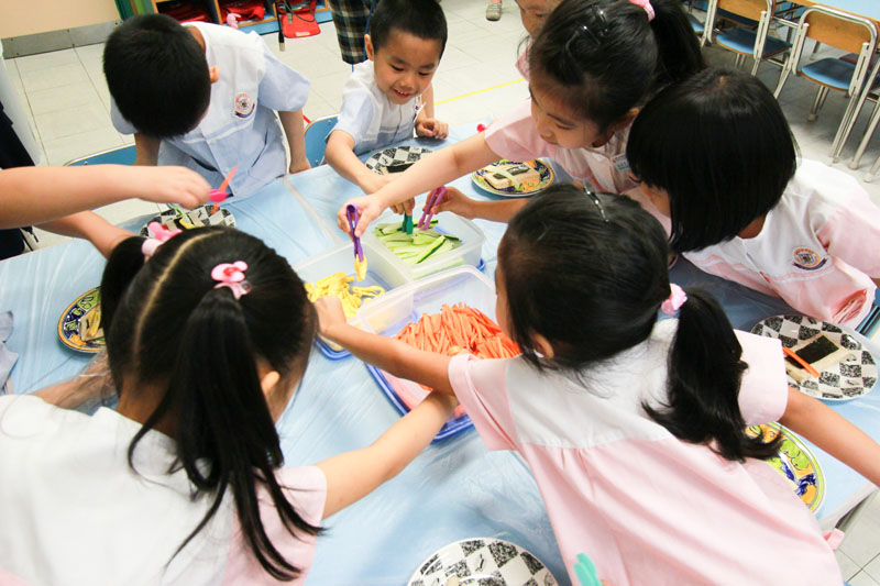 Children are making nutritional snacks together