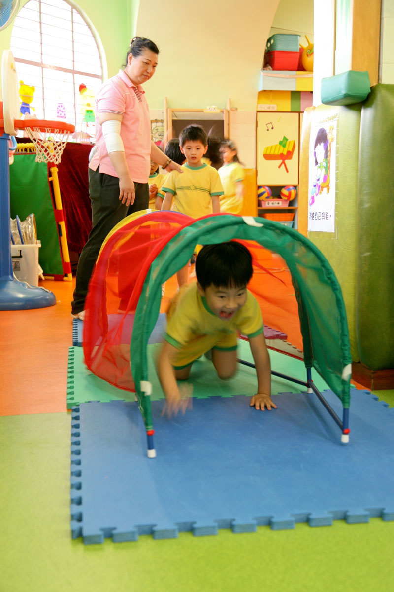 A child is passing through a tunnel