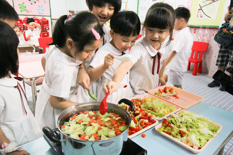 Children are cooking vegetables soup